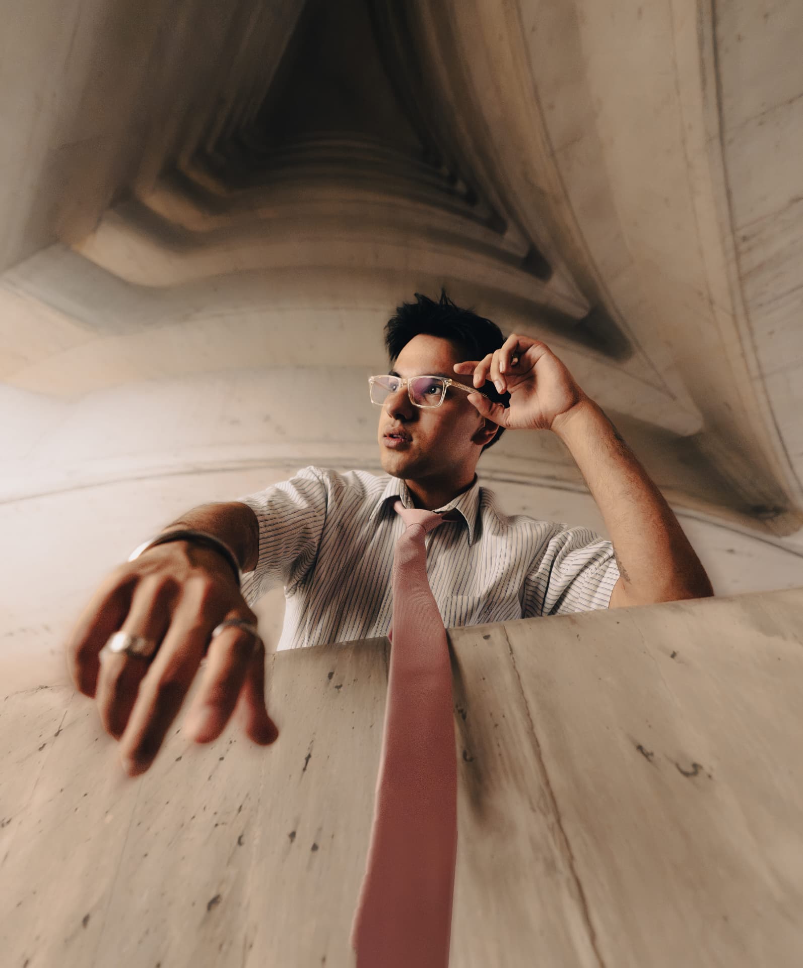 Aakash photographed from below against a stone facade